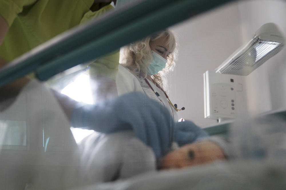 A doctor checks a baby's ears in a maternity hospital in Kyiv.