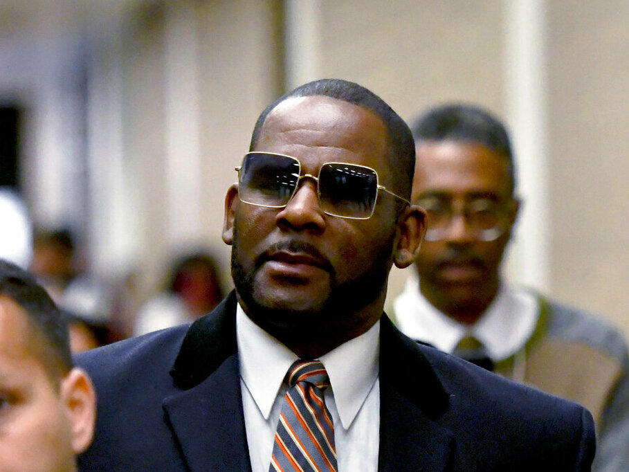 R. Kelly, center, leaves the Daley Center after a hearing in his child support case in May 2019 in Chicago.