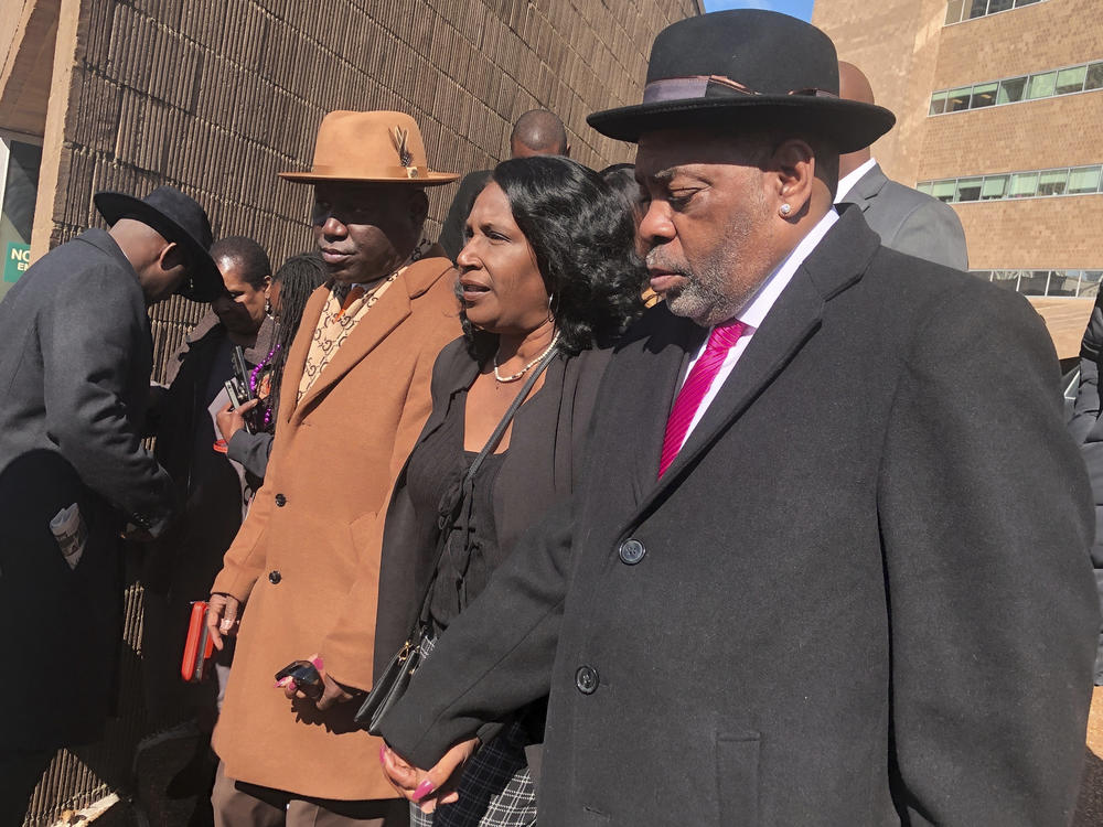 Attorney Ben Crump (from left) Tyre Nichols' mother, RowVaughn Wells, and stepfather, Rodney Wells, exit the courthouse in Memphis after five former Memphis police officers pleaded not guilty Friday to second-degree murder and other charges in Nichols' death.