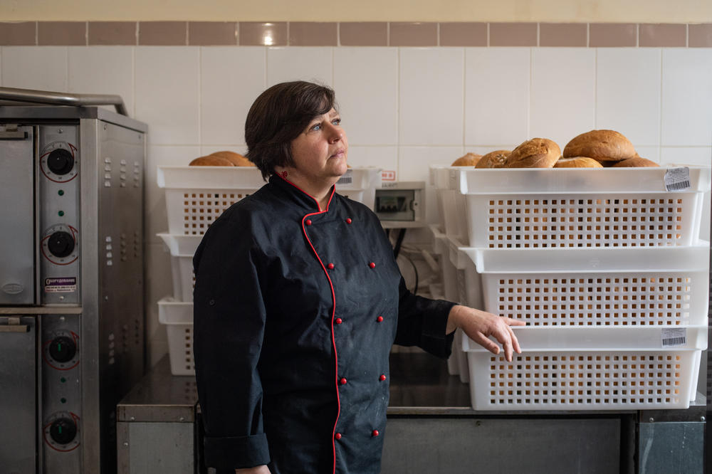 Olha Chupikova, a 48-year-old landscape designer who spied on the occupying Russian forces, poses inside the bakery where she now helps to bake bread to distribute to local residents in Kherson, Ukraine.