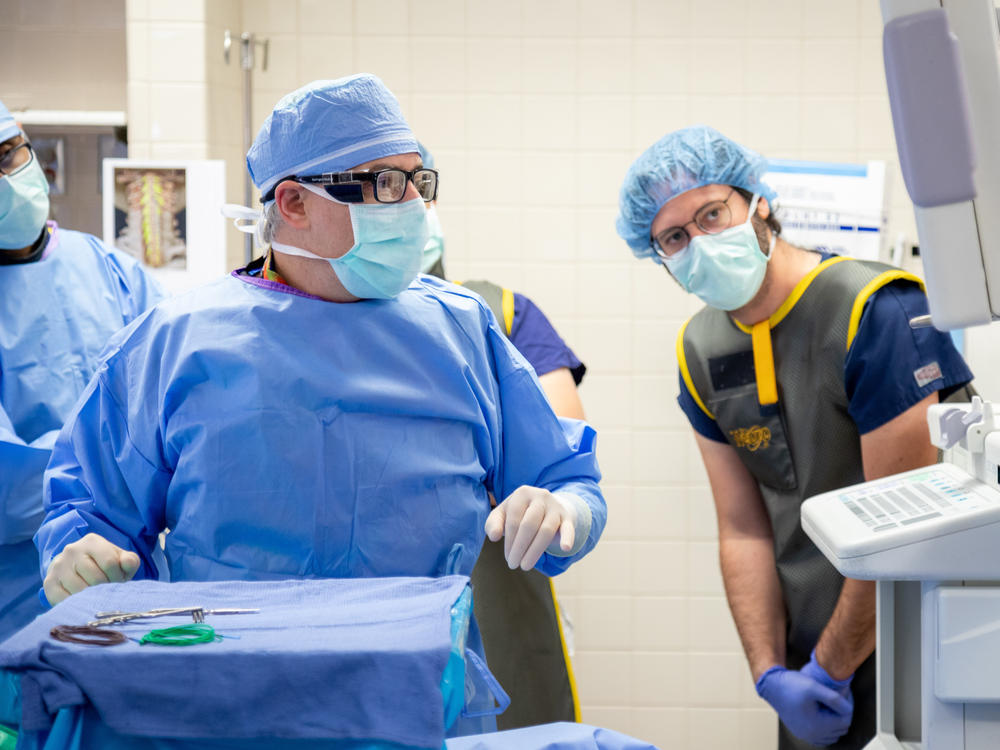 University of Pittsburgh neurosurgeon Dr. Peter Gerszten (left) and assistant professor of neurosurgery Marco Capogrosso, during the implantation procedure at UPMC Presbyterian hospital.