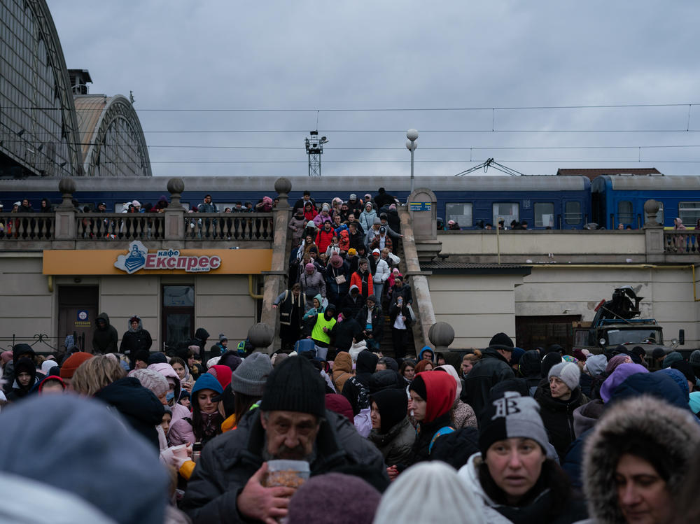 Displaced people from eastern Ukraine spill out of a train station in Lviv, in western Ukraine, last March. At this point, more than 2 million people had fled the country as a result of Russia's invasion.