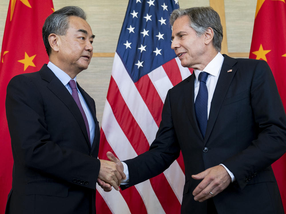 U.S. Secretary of State Antony Blinken shakes hands with China's top diplomat Wang Yi during a meeting in Nusa Dua on the Indonesian resort island of Bali on July 9, 2022.