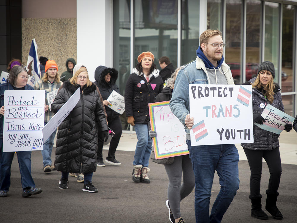Protestors calling for LGBTQ rights stand outside a Pizza Ranch in Cedar Rapids, Iowa, where former Vice President Mike Pence is speaking on Feb. 15, 2023.