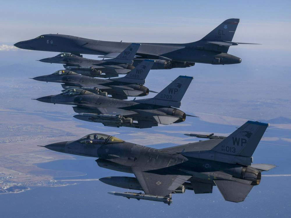 In this photo provided by South Korea Defense Ministry, a U.S. Air Force B-1B bomber, top, flies in formation with U.S. Air Force F-16 fighter jets over the South Korea Peninsula during a joint air drill in South Korea, Sunday, Feb. 19, 2023.