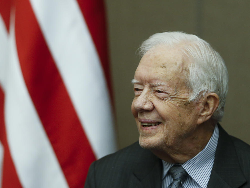 Former President Jimmy Carter smiles as he is awarded the Order of Manuel Amador Guerrero by Panamanian President Juan Carlos Varela during a ceremony at the Carter Center, Jan. 14, 2016, in Atlanta.