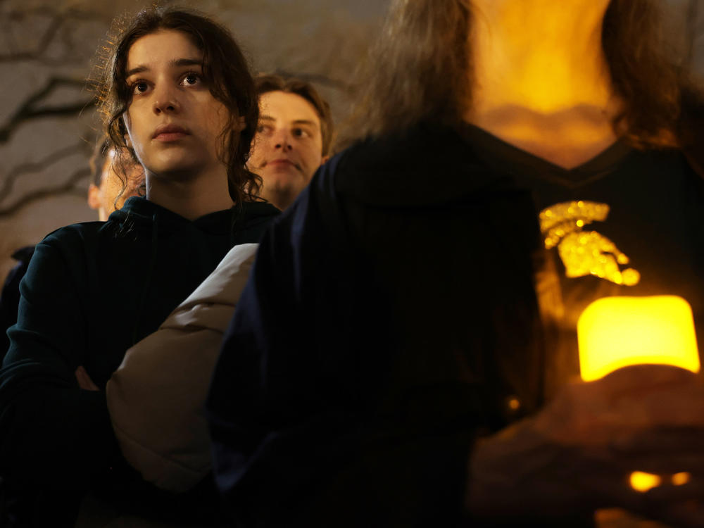 People attend a candlelight vigil, for the victims of a shooting at Michigan State University, on Feb. 16. Classes are scheduled to resume days later.