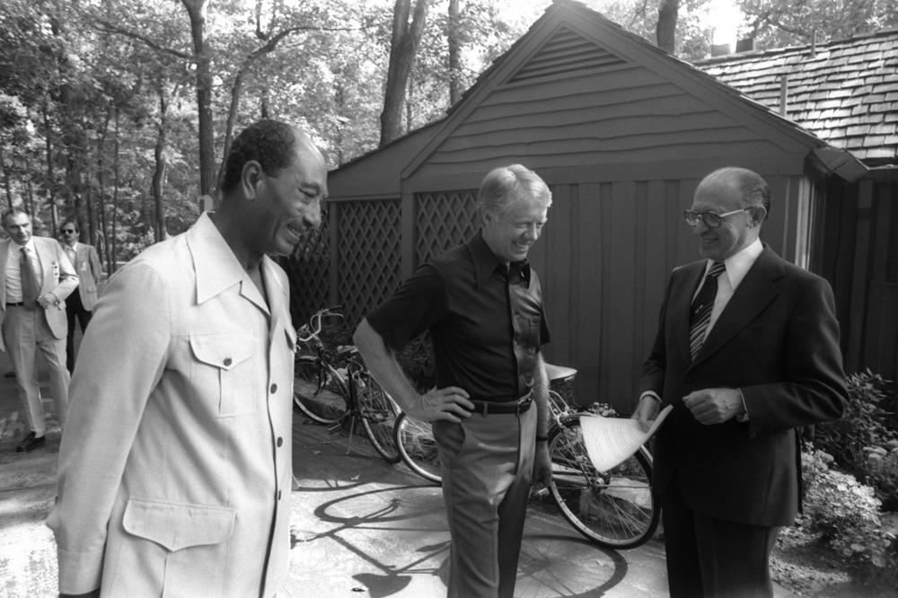 In this handout file photo, Israeli Prime Minister Menachem Begin chats informally with Egyptian President Anwar el-Sadat and President Carter during their peace talks on Sept. 6, 1978, at Camp David in Maryland.