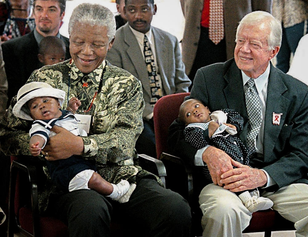 Former President Jimmy Carter has worked to end neglected diseases since 1982. Here he sits with former South African President Nelson Mandela at a ceremony in Soweto in 2002, marking a new AIDS project.