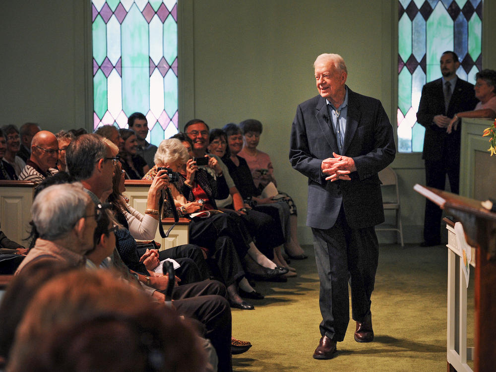 Former President Jimmy Carter greets worshippers at Maranatha Baptist church in Plains, Ga., on Oct. 10, 2010.