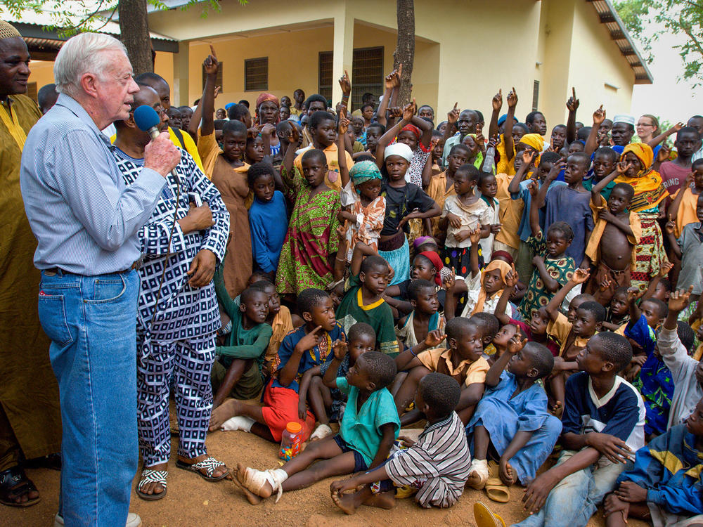 On a 2007 visit to Savelugu Hospital in Ghana, President Jimmy Carter asks a group of children if they've had Guinea worm. A raised hand is a yes.