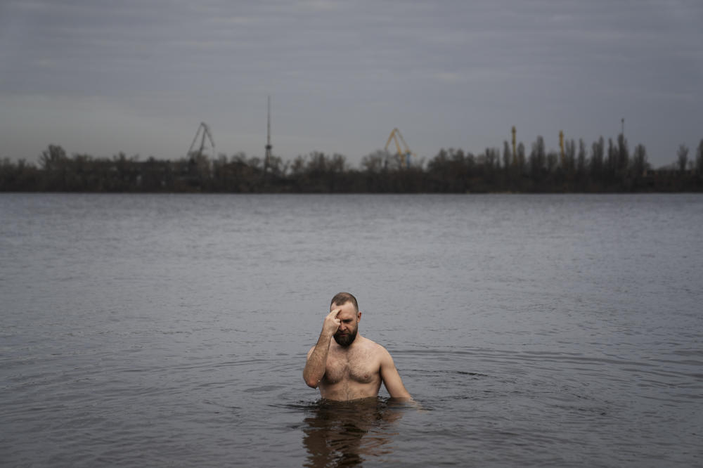 Nikolai Pastuchenko crosses himself as he dips in the river in Dnipro as part of a tradition for the Eastern Christian holiday the Epiphany in January.