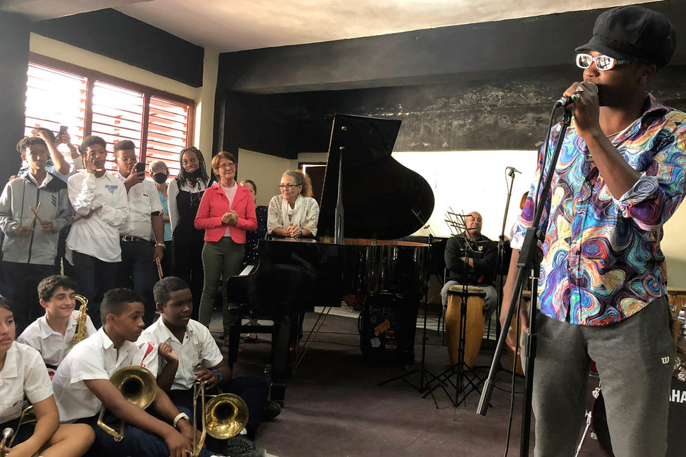 The Cuban singer Cimafunk speaks to students during a cultural exchange at the Guillermo Tomas music conservatory.