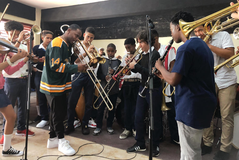 New Orleans trombonist Revon Andrews, foreground, teaches a song to students.