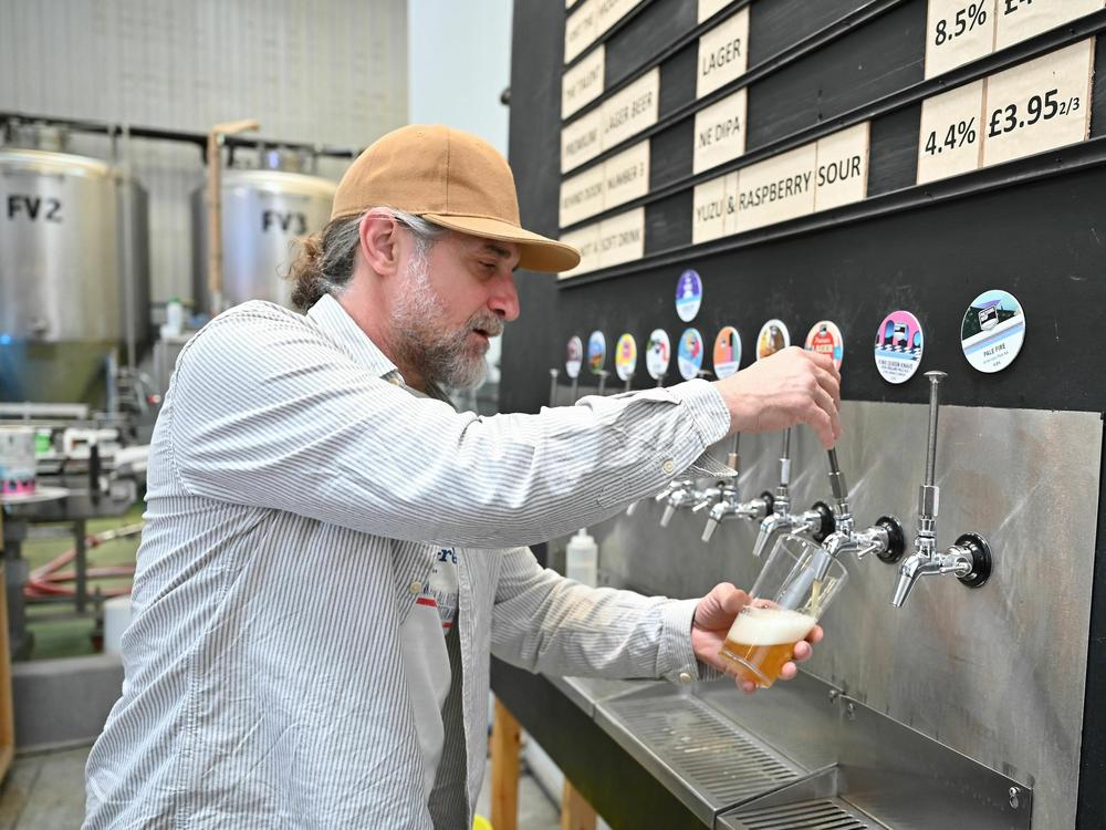 A worker pours a pint of beer at London's Pressure Drop Brewery, one of 61 U.K. employers that participated in a six-month trial of a four-day workweek.
