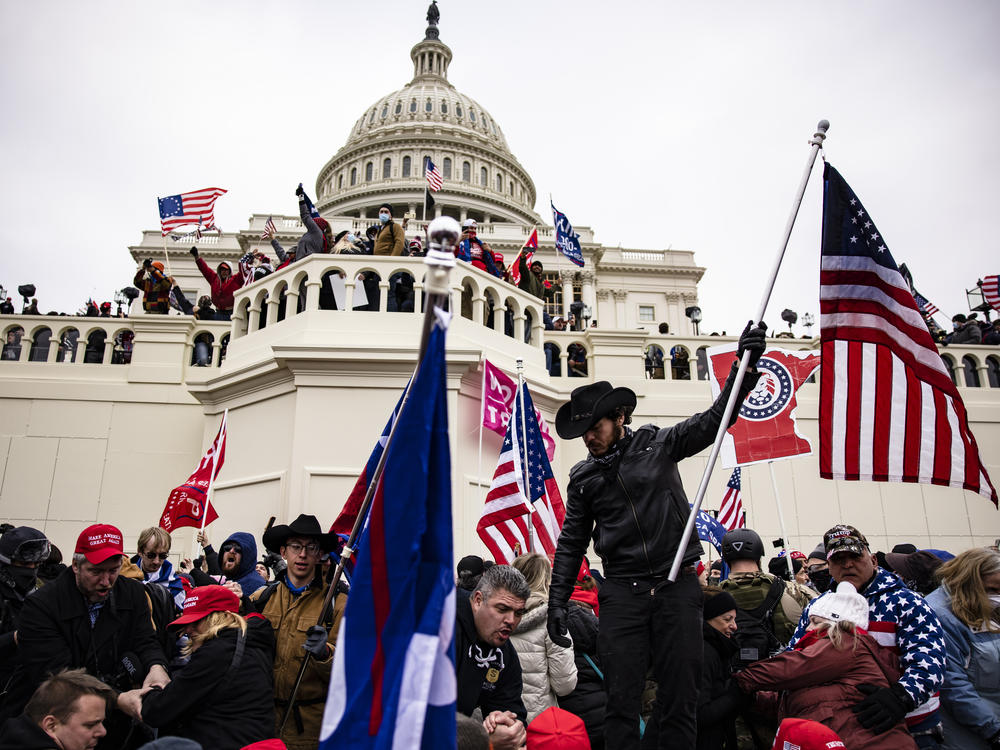 A crowd of pro-Trump supporters storm the U.S. Capitol on Jan. 6, 2021. Senate Majority Leader Chuck Schumer is warning against the release of security footage from during the Capitol attack to Fox News host Tucker Carlson.