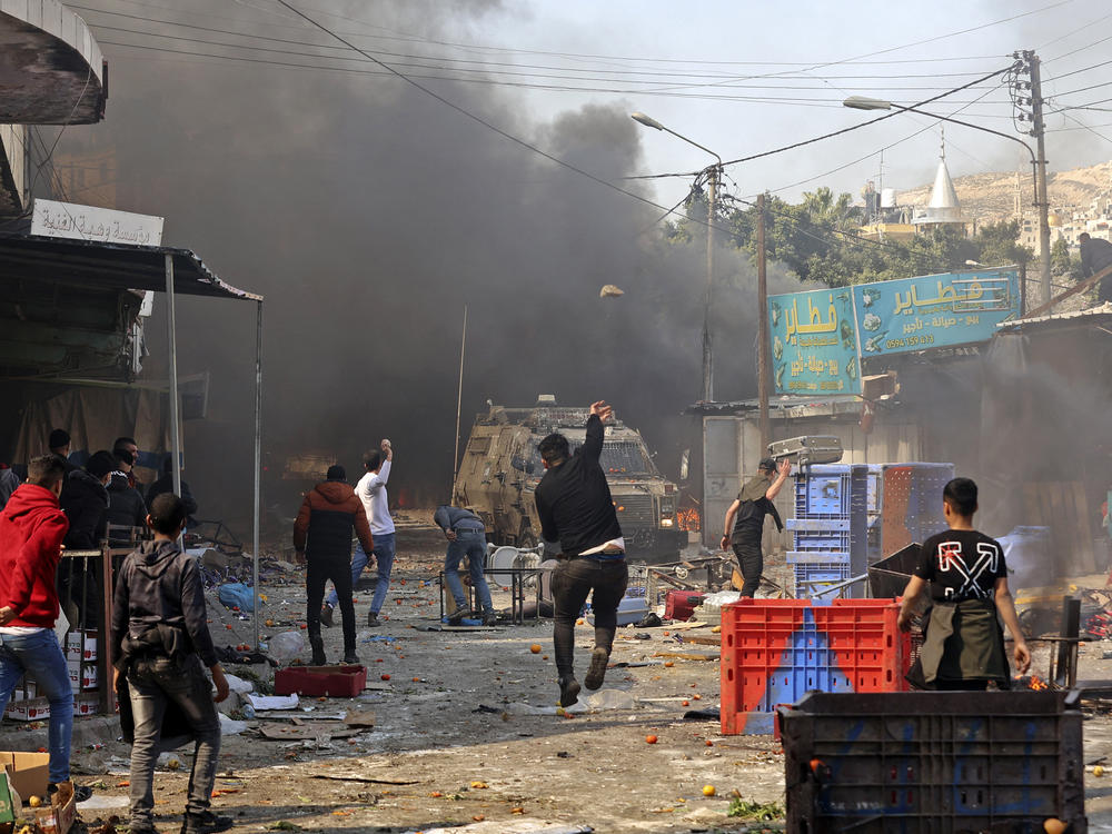 Palestinians clash with Israeli security forces during a raid in the occupied West Bank city of Nablus, on Feb. 22. The raid left scores of people hurt and killed 10 Palestinians. Israel's military says it suffered no casualties.