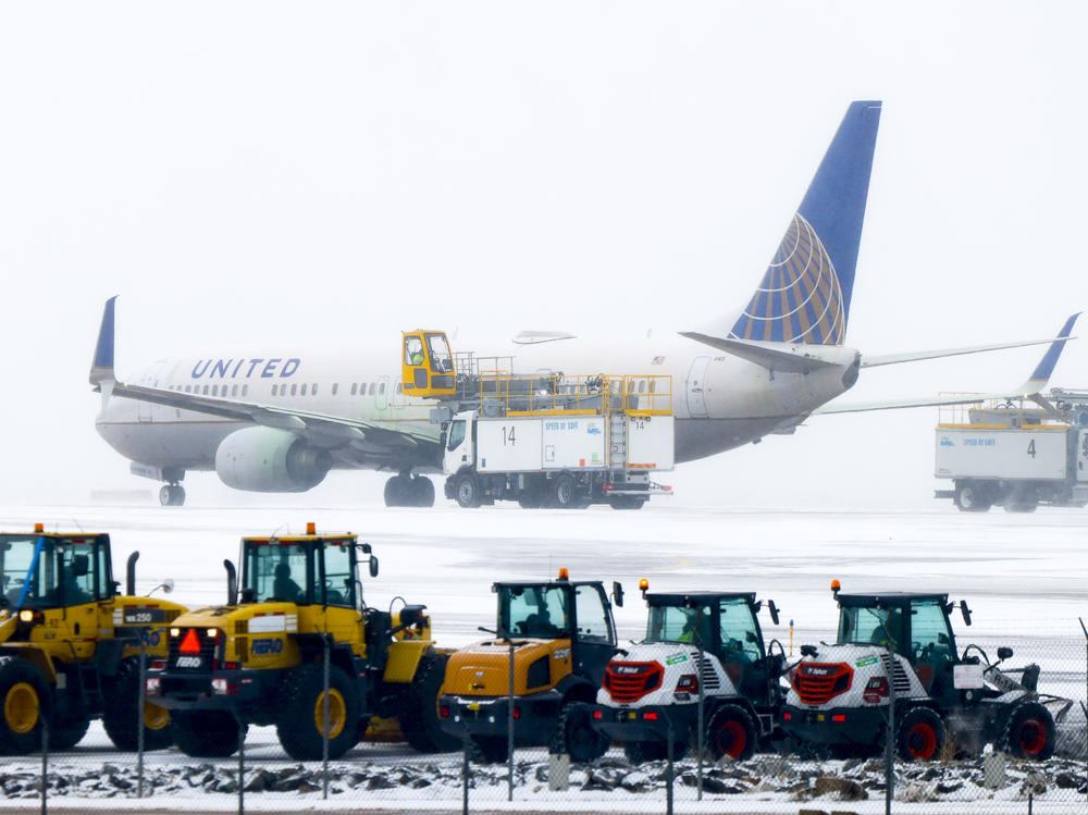 A United Airlines flight is de-iced before takeoff during a winter storm at Denver International Airport on Wednesday in Denver.