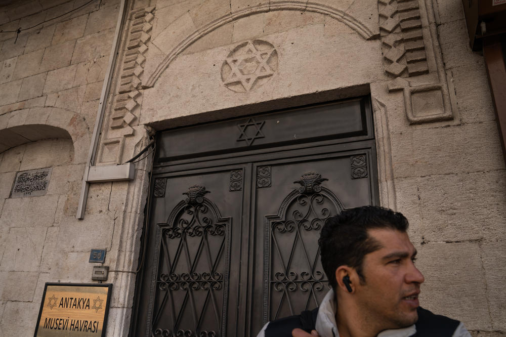 Yusuf Kocaoglu stands in front of the synagogue in Antakya, which is still standing. The head of Antakya's tiny Jewish community died in the earthquake.