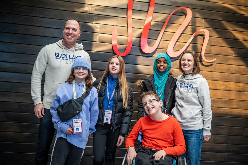 Glen Lake Elementary Principal Jeff Radel, students Caleigh Brace, Hadley Mangan, Raqiya Haji, teacher Betsy Julien; and student John Buettner, (front) pose for a portrait during a visit to Landscape Structures in Delano, Minn.