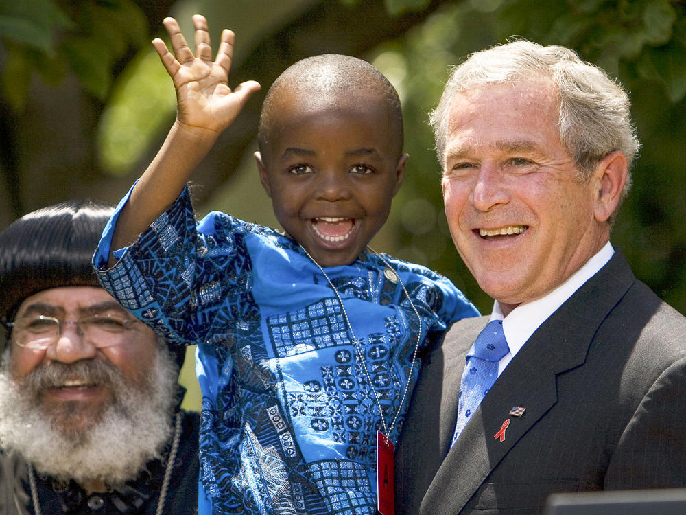 In 2003, President George W. Bush created PEPFAR to help countries tackle the HIV/AIDS crisis. Four years later, he spoke at the Rose Garden to urge lawmakers to set aside $30 billion for the cause over the next 5 years. Joining him were Kunene Tantoh of South Africa and her 4-year-old son (pictured). Tantoh, who is HIV-positive, coordinated a U.S.-funded mentoring program for mothers with HIV.