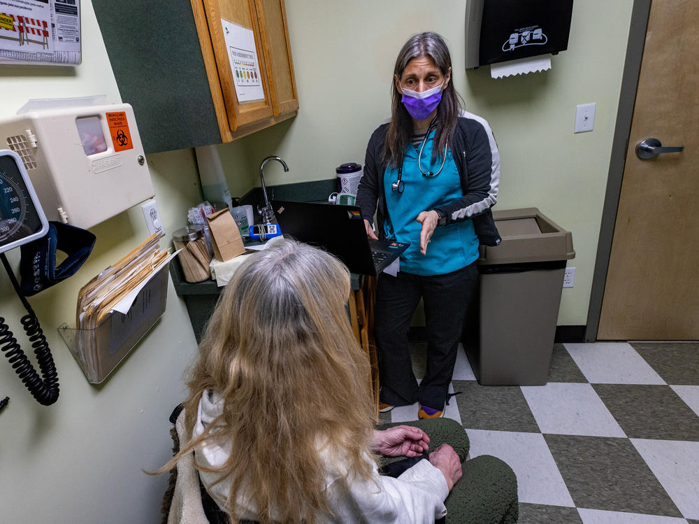 Registered nurse Jamie Simmons speaks with a patient during an appointment at the Greater New Bedford Community Health Center in Massachusetts. The patient, whose first name is Kim, says buprenorphine has helped her stay off heroin and avoid an overdose for nearly 20 years.