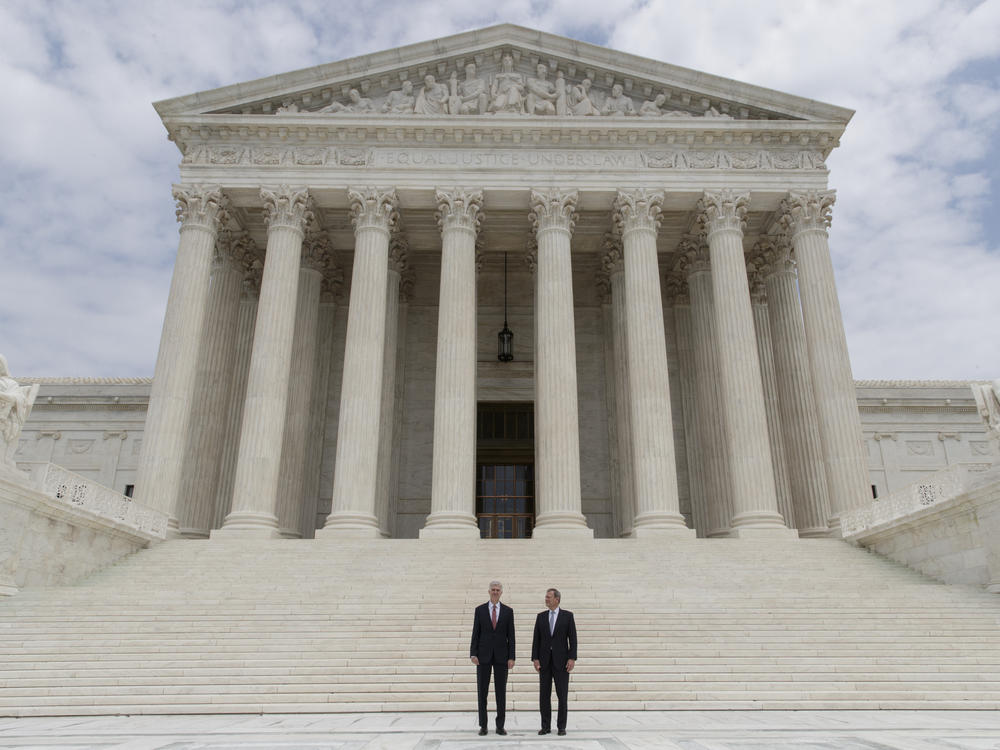 U.S. Supreme Court Justice Neil Gorsuch (left) stands next to Chief Justice John Roberts outside the court in 2017.