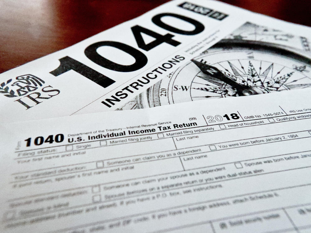Internal Revenue Service tax forms are seen on a table. Black married couples are dealing with higher penalties compared with white married couples, a new report indicates.
