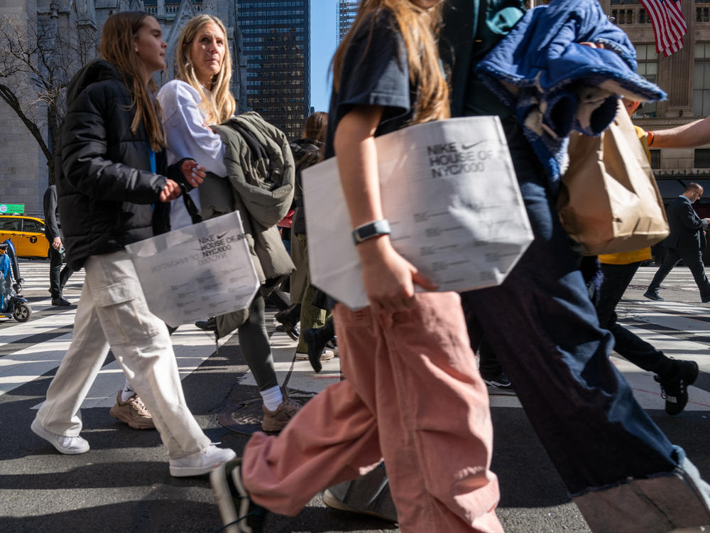 People walk along 5th Avenue in Manhattan, which is one of the nation's premier shopping streets, on Feb. 15, 2023. Consumer spending was unexpectedly strong last month. That's good for the economy – but not so good for inflation prospects.
