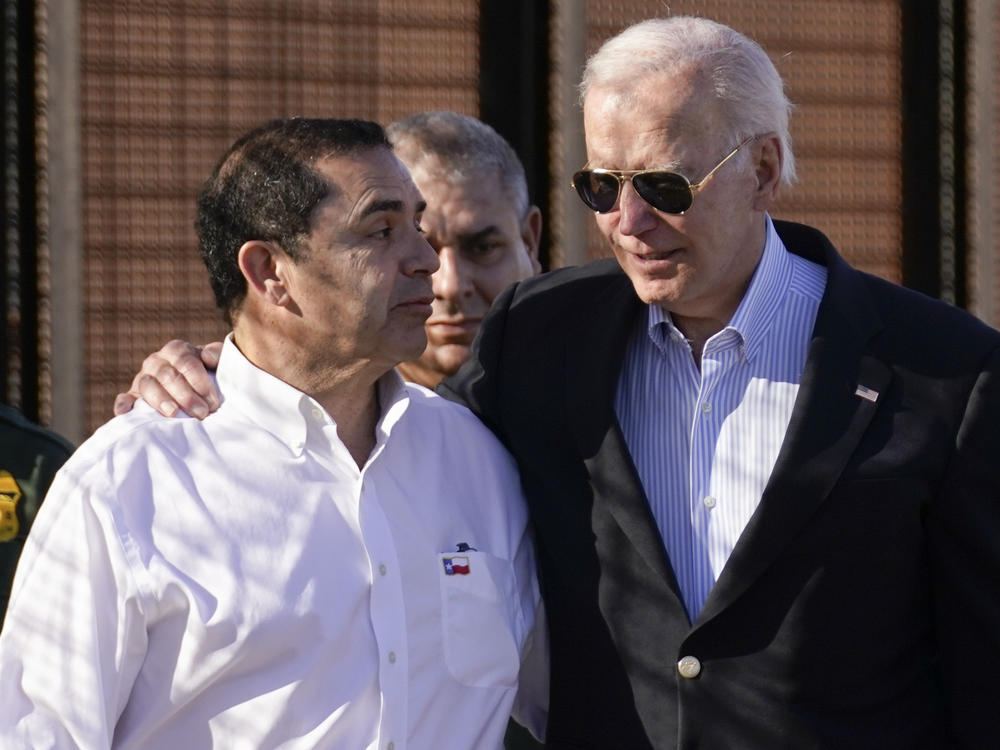 President Joe Biden talks with Rep. Henry Cuellar, D-Texas, left, as they walk along a stretch of the U.S.-Mexico border in El Paso Texas, last month.