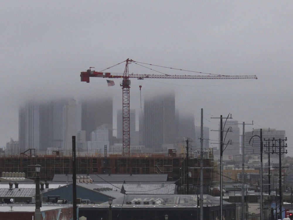 Storm clouds cloak downtown high rises in Los Angeles, Saturday, Feb. 25, 2023, as a major winter storm sweeps through California. The storm piled snow high in the mountains and dropped heavy rain. The National Weather Service said it was 
