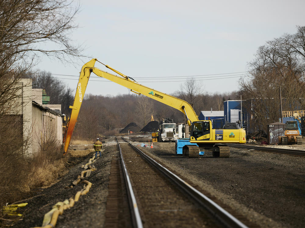 Workers remove contaminated dirt near the railroad tracks on February 14, 2023 in East Palestine, Ohio.