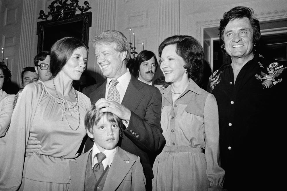 June 14, 1977: President and Mrs. Carter chat with singers Johnny Cash and his wife June Carter during a visit the couple paid to the White House, in Washington, D.C. With them is the singer's son, John Carter Cash. Earlier, Cash sang at Flag Day ceremonies at the Capitol.