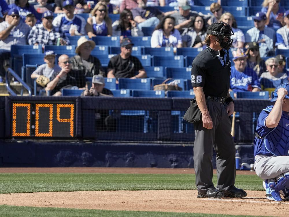 Home plate umpire Jim Wolf waits as the pitch clock counts down during the first inning of a spring training baseball game between the Milwaukee Brewers and the Los Angeles Dodgers Saturday in Phoenix.