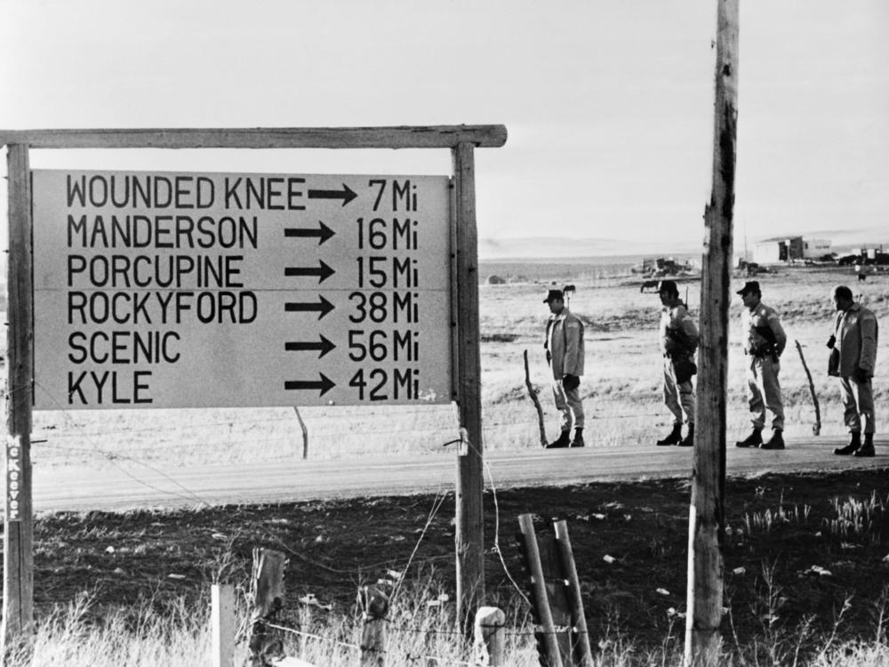 Federal troops block the road near Wounded Knee in March 1973.
