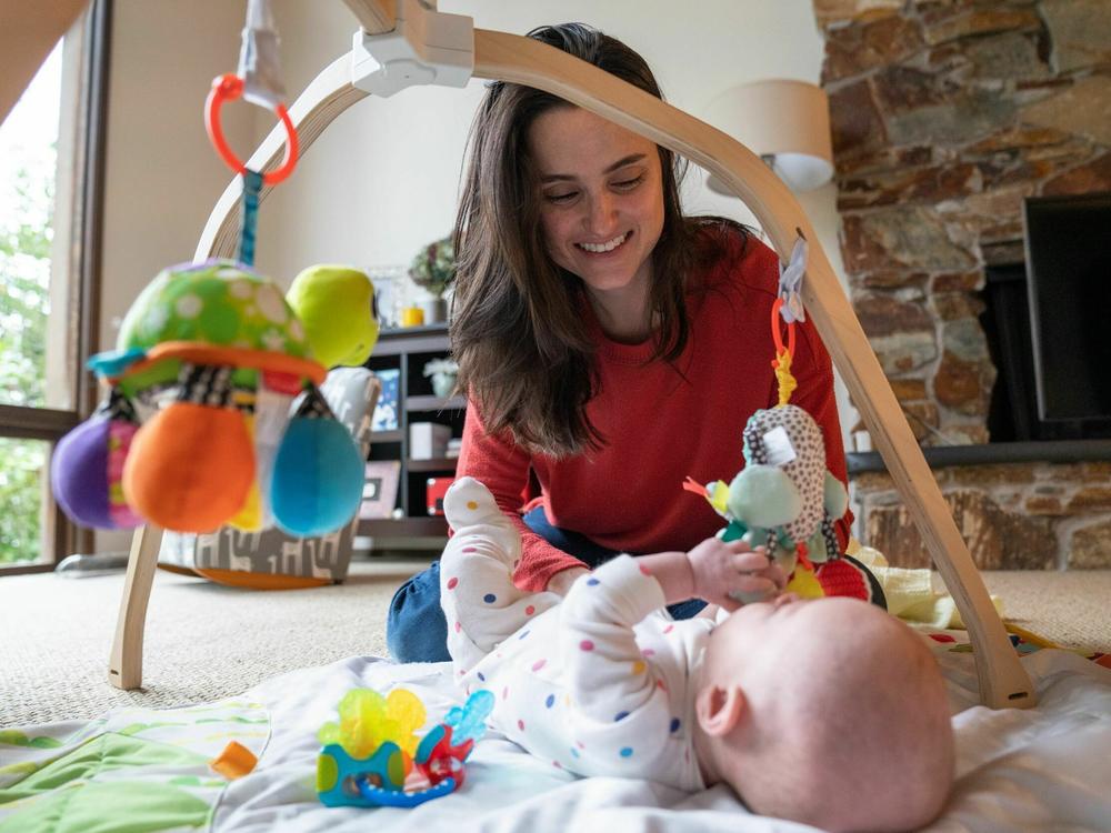 Danielle Laskey at her home just outside Seattle, with her infant son. Before giving birth, Laskey experienced a serious pregnancy complication and was admitted for a seven-week hospital stay, plus a follow-up postpartum procedure.
