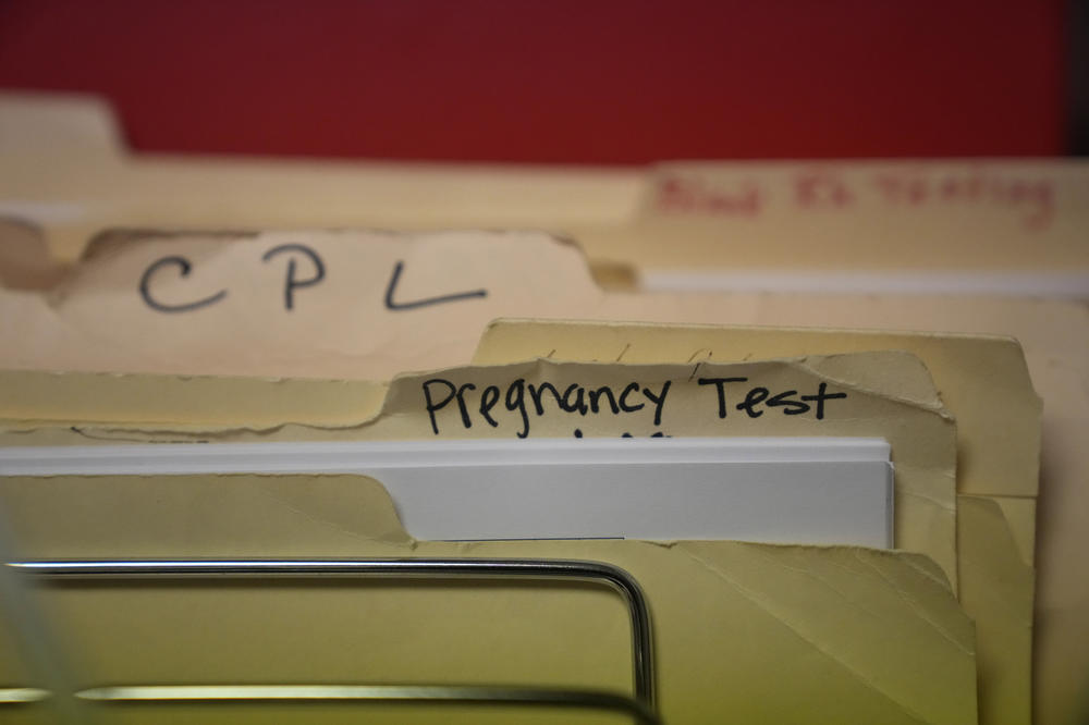 Folders rest on a rack in a lab at Hope Medical Group for Women in Shreveport, La., in 2021. The nation's most restrictive abortion law is driving many women from Texas to seek services in neighboring states.