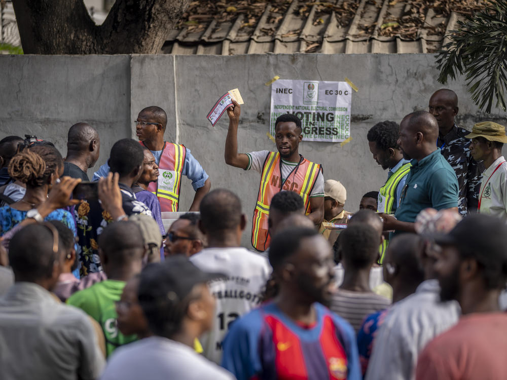 An electoral officer holds up votes as they are counted at a polling station in Lagos, Nigeria