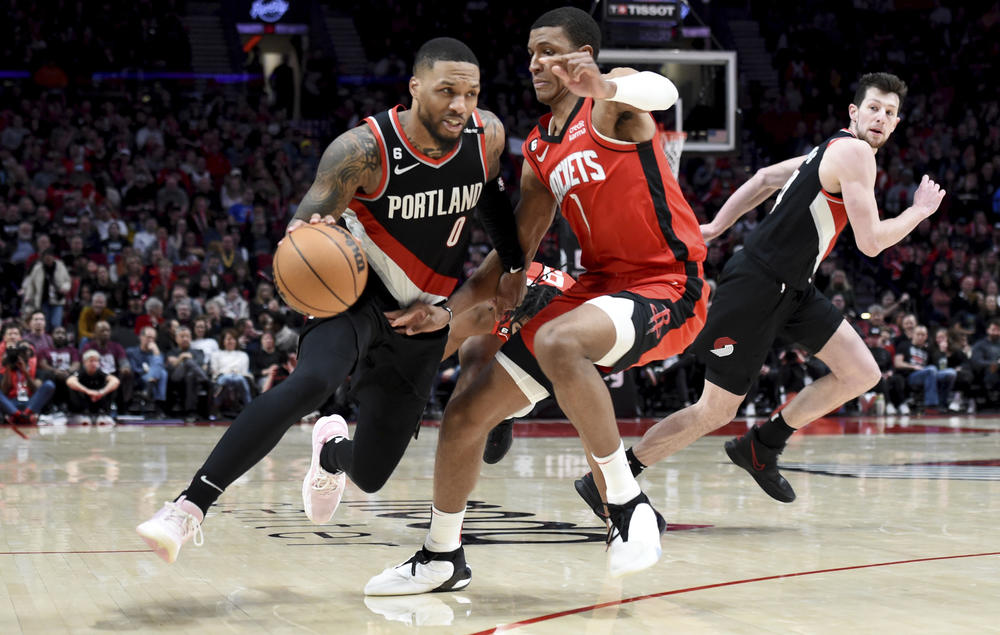 Portland Trail Blazers guard Damian Lillard, left, drives to the basket on Houston Rockets forward Jabari Smith Jr., right, during their NBA basketball game in Portland, Ore., Sunday, Feb. 26, 2023. Lillard scored a franchise record 71 points as the Blazers won 131-114.