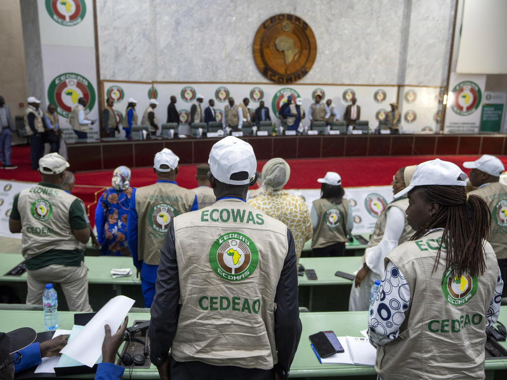 Members stand for the arrival of dignitaries at a joint press conference by African Union (AU) and Economic Community of West African States (ECOWAS) electoral observers in Abuja, Nigeria