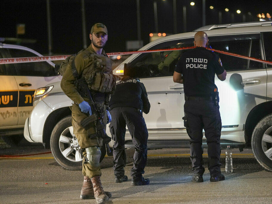 Israeli security forces examine the scene of a shooting attack in the West Bank on Monday.