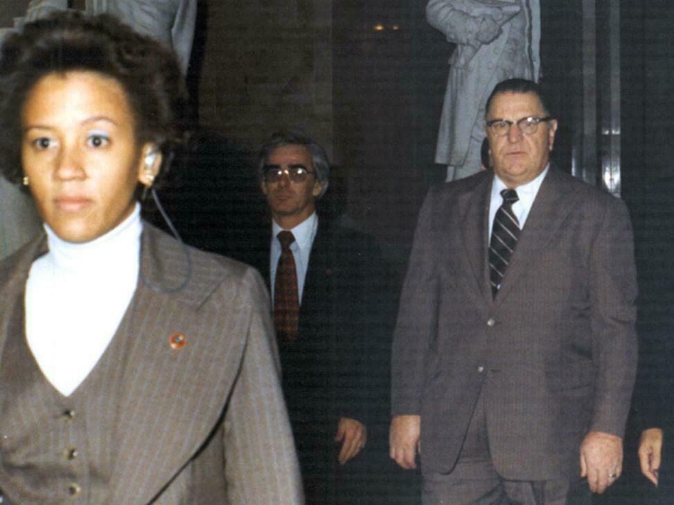 Zandra Flemister, the first Black woman special agent in the Secret Service, left the agency after four years because of discrimination. She is seen here escorting Prime Minister of Jamaica Michael Manley (right) during his 1977 visit to Washington.