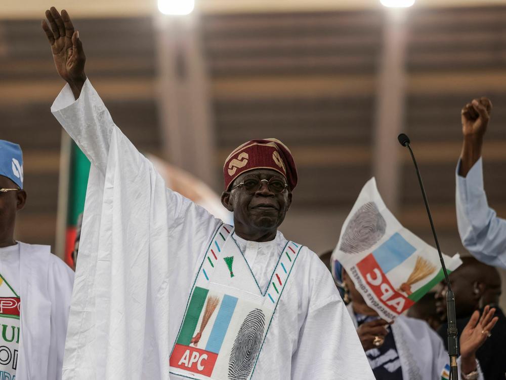 Bola Tinubu gestures toward the crowd during a campaign rally in Lagos. He has been declared the winner of Nigeria's presidential elections.