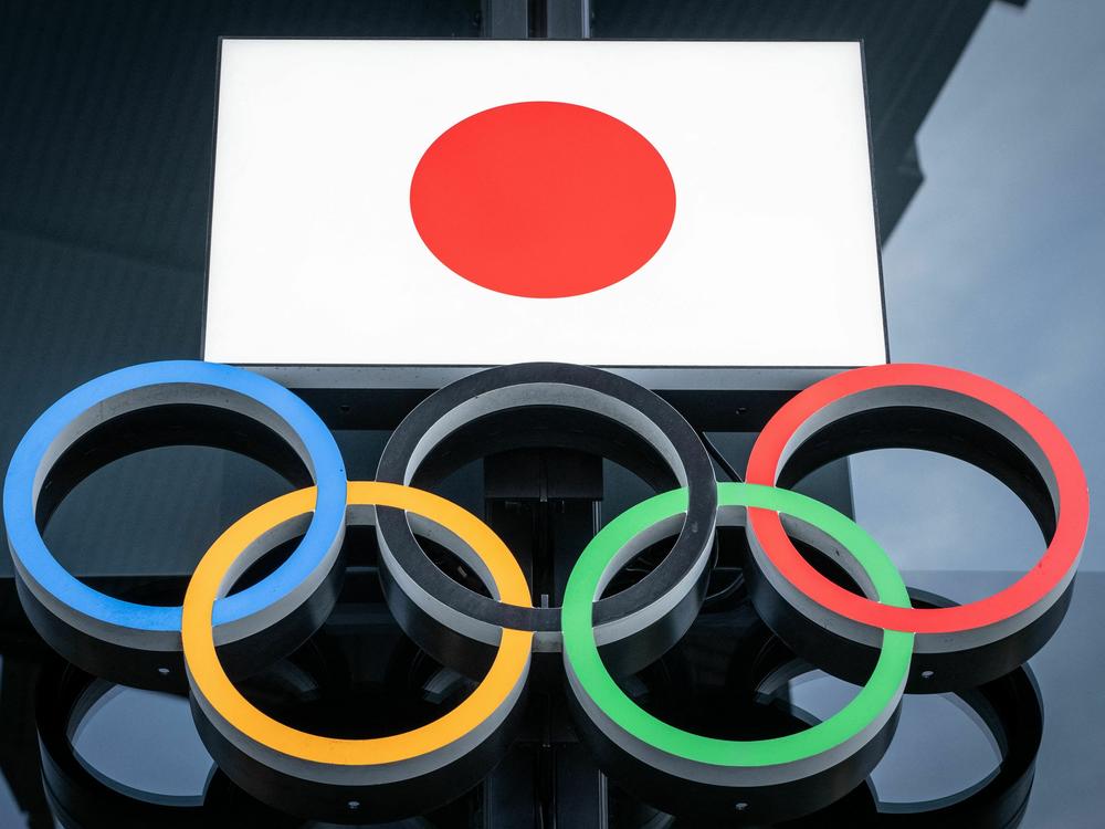 The Japanese flag and Olympic rings are seen at the Japan Olympic Museum near the National Stadium in Tokyo on Feb. 17.