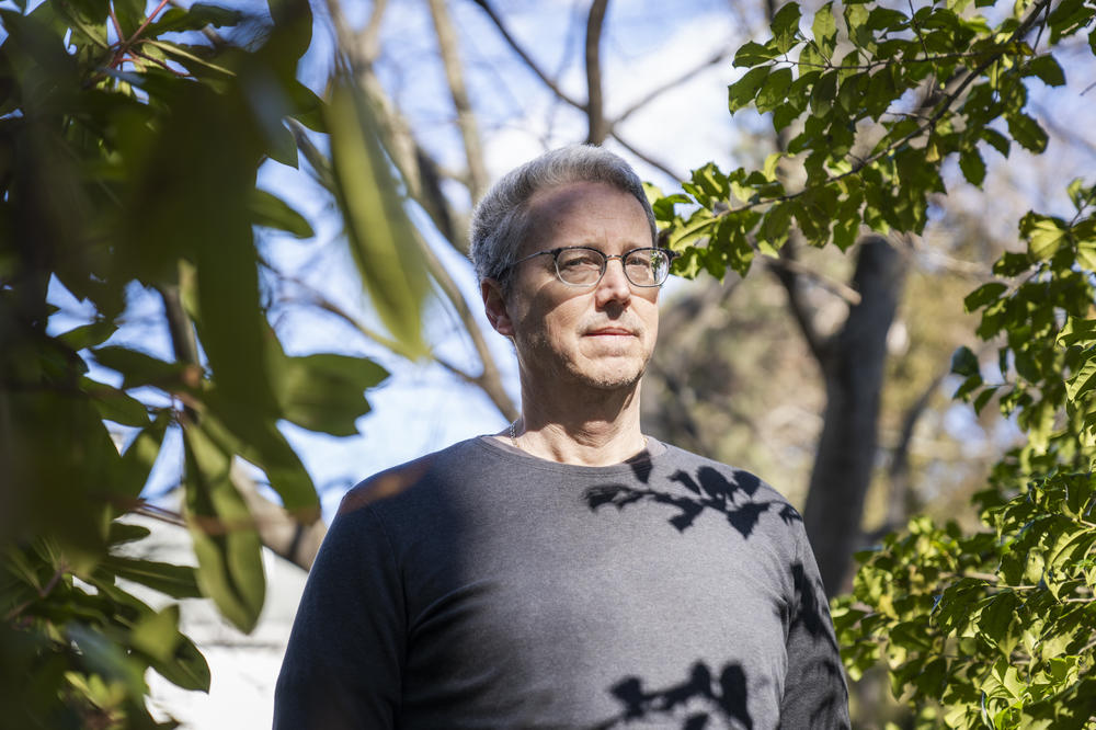 Glenn Morgan, whose father died in the 9/11 attacks, stands in his backyard in Belmont, Mass.