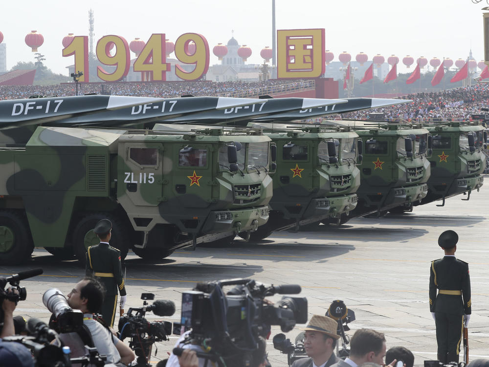 Military vehicles, carrying DF-17, roll down as members of a Chinese military honor guard march during the parade to commemorate the 70th anniversary of the founding of Communist China in Beijing, Oct. 1, 2019. China's military showed off a new hypersonic ballistic nuclear missile in the parade.