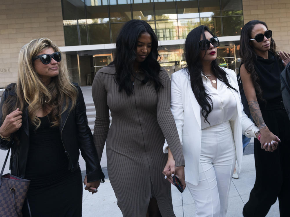 Vanessa Bryant, center, Kobe Bryant's widow, leaves a federal courthouse with her daughter Natalia and soccer player Sydney Leroux in Los Angeles, Aug. 24, 2022.