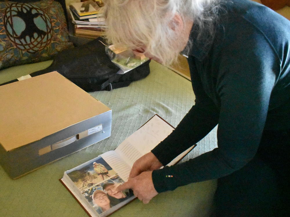 Jennifer Mitchell looks through pictures of travels with her husband, Bill. After Bill was discharged from the Montana State Hospital, Jennifer discovered he was taken off some of his congestive heart failure medications. He later suffered a cardiac arrest and died in hospice care.