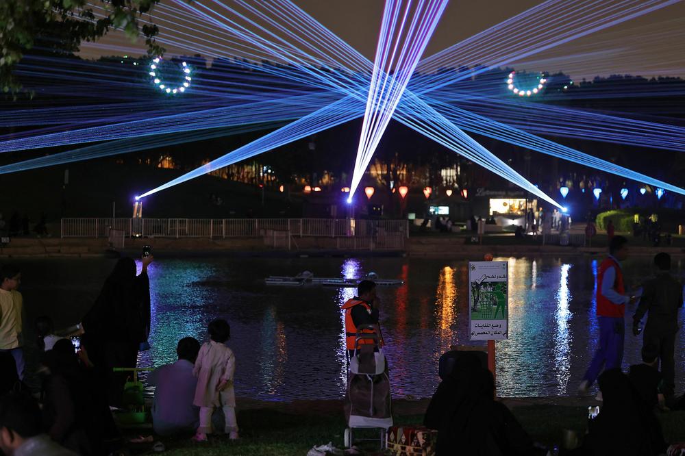 A picture taken November 3, 2022 shows Saudis attending the Noor Riyadh lighting festival held at Al-Salam Park in the Saudi capital Riyadh. - Noor Riyadh, brings light installations to more than 40 locations in a fast-growing city of more than seven million people, many of whom may never consider dropping in on a gallery.