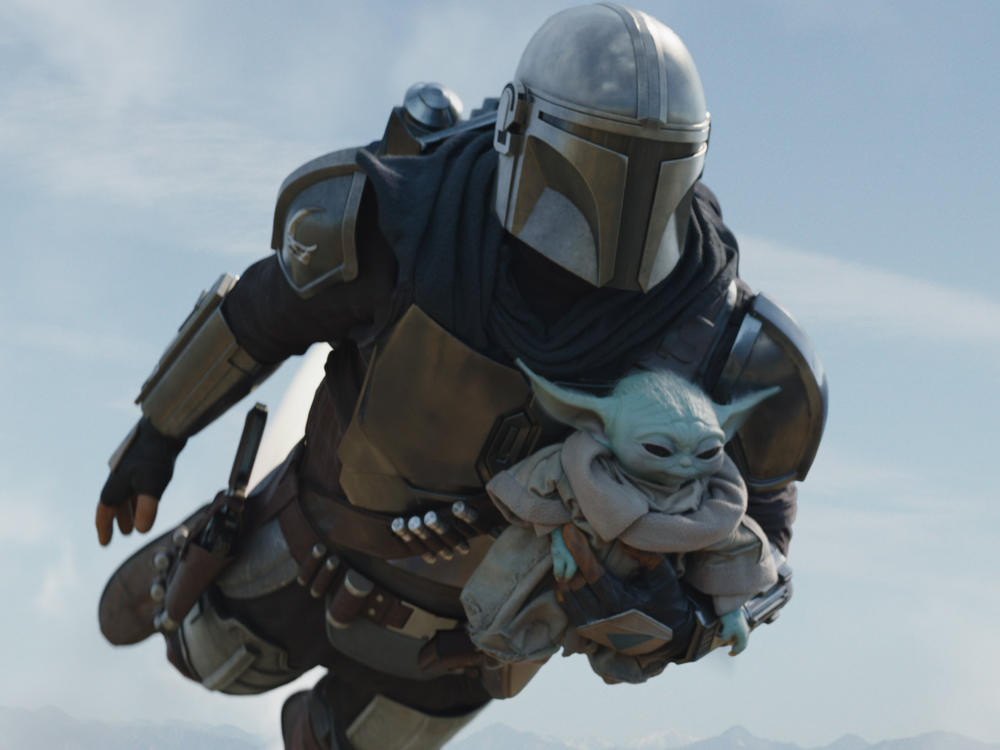 The Mandalorian (Pedro Pascal) and Grogu in Season 2 of <em>The Mandalorian.</em>